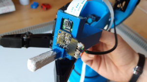 Test automation using a robotic arm